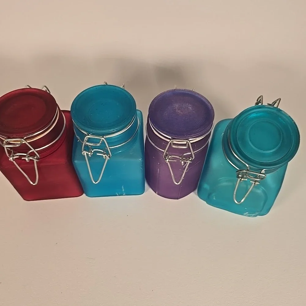 Set Of Four Colored‎ Glass Cannisters With Locking Tops Very Good Condition